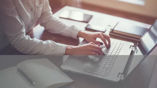 Woman typing on laptop